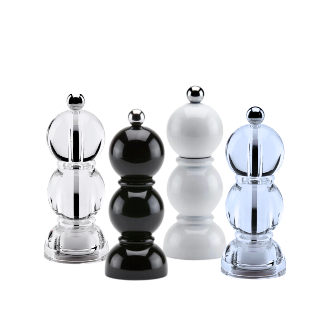 Four Addison Ross Mini Bobbin Salt & Pepper Shakers—clear, black, white, and light blue—feature a rounded modern design with high-gloss lacquer and metallic knob, plus a ceramic grinder for smooth seasoning.