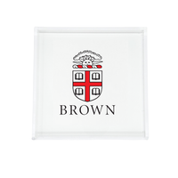 The Eye Candy College Acrylic Catchall Tray displays the Brown University coat of arms with a red cross, four open books, and "BROWN" below—a stylish and practical dorm room accessory.
