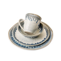 The Simon Pearce Burlington Dinnerware Pool set features a cup, bowl, salad plate, and dinner plate with blue and gray watercolor-like glaze accents on white.