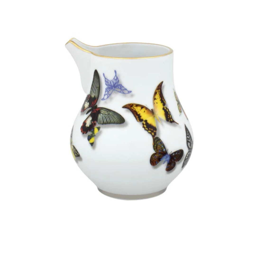 A white porcelain creamer with a gold rim from Vista Alegre’s Butterfly Parade Dinnerware features colorful butterfly illustrations—ideal for luxury dinnerware collections or mixing and matching your tableware style.