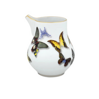 A white porcelain creamer with a gold rim from Vista Alegre’s Butterfly Parade Dinnerware features colorful butterfly illustrations—ideal for luxury dinnerware collections or mixing and matching your tableware style.