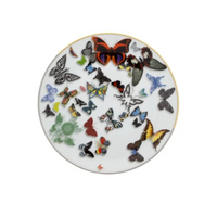 A white plate with a gold rim from Vista Alegre’s Butterfly Parade Dinnerware features colorful butterflies in assorted sizes and patterns, ideal for elevating luxury table settings or mixing and matching with other dinnerware.