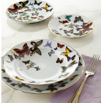 Four white porcelain plates of various sizes from the Vista Alegre Butterfly Parade Dinnerware collection, featuring colorful butterflies and gold rims, arranged on marble—a stunning luxury set perfect for mixing and matching.