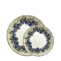 Two Marie Daâge Cercle d'Ecailles Dessert Plates, crafted in ceramic with hand-painted blue and green scalloped rims, overlap on a white background—showcasing the brand’s elegant artistry.