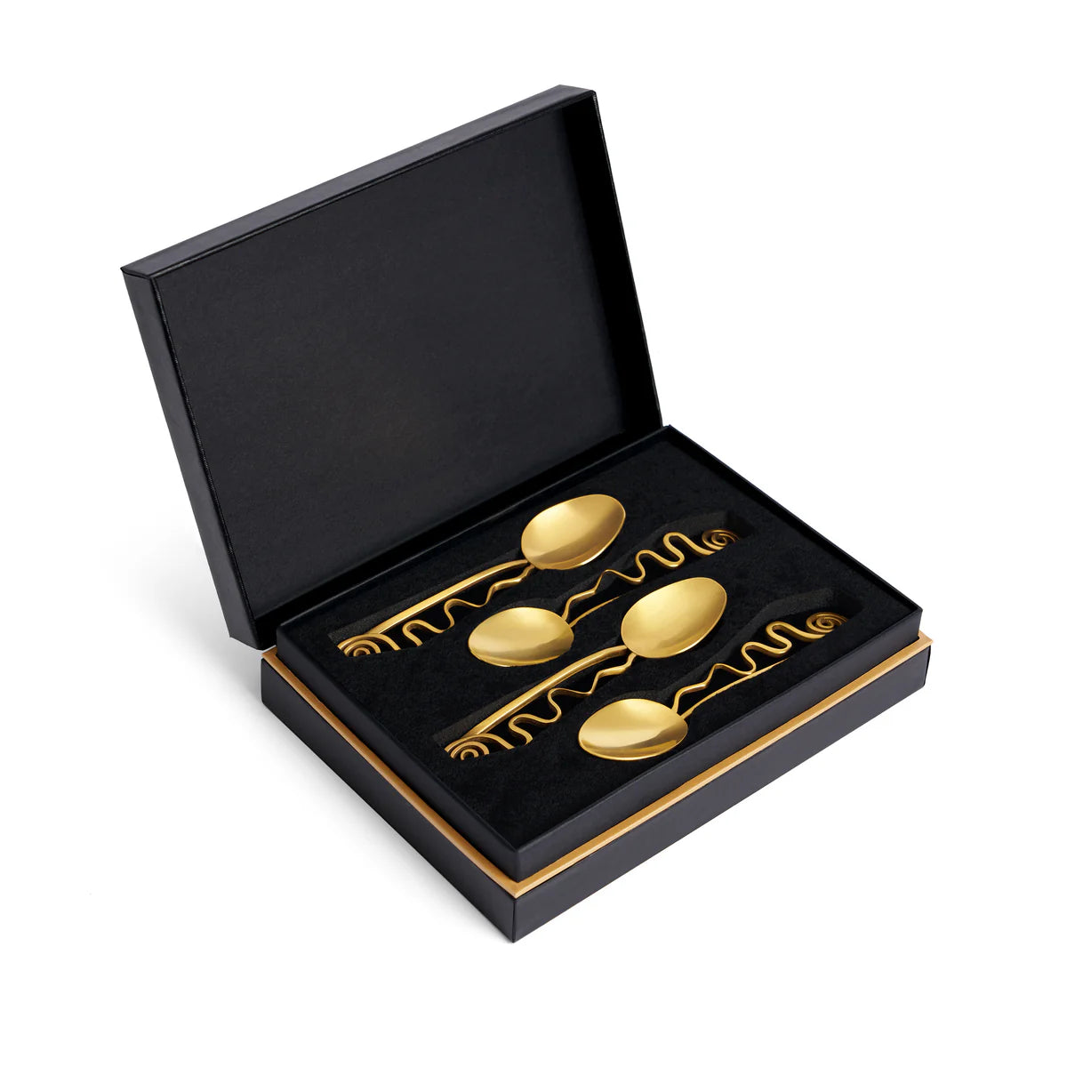 The Spirale Gold Cocktail Spoons Set of 4 by L'Objet features ornate, wavy 24k gold-plated spoons in a black and gold luxury gift box with a partially open lid and black foam insert.