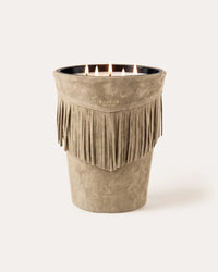 A four-wick Baobab Calamity Jane Candle - The Plains in a light brown, fringed vessel.