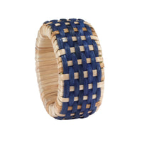 The Bodrum Cane Napkin Ring Set of 4 features chunky, textured woven rings in natural and blue fibers with a checkered pattern—ideal for adding rustic charm to your table setting.