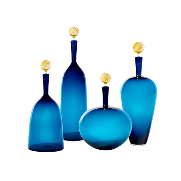 Four handblown Carmella Decanters in Steel Blue & Gold by Cariati, each with textured 24K gold stoppers, stand against a white background—exemplifying exquisite barware craftsmanship.