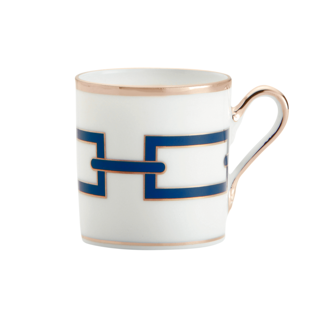 Ginori 1735 Catene Zaffiro coffee cup: white porcelain with gold trim and a blue interlocking geometric pattern, inspired by the iconic dinnerware collection.