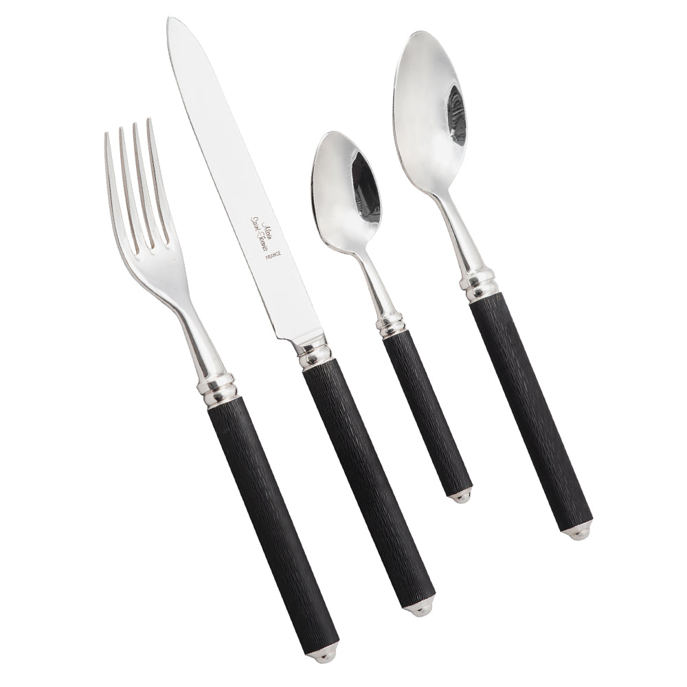 The Alain Saint-Joanis Cedre Black 5 Piece Setting features silver-plated flatware with textured black handles, including a fork, knife, tablespoon, teaspoon, and dessert spoon—displayed side by side on a white background.