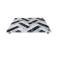 The Eye Candy Raised Serving Board Marble features a black and white chevron pattern and sturdy metal feet—a stylish choice for serving sushi or as a modern challah board.