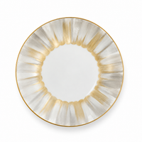 Marie Daâge Panache white Limoges porcelain plate with a wide, fluted rim featuring alternating gray and metallic gold brushstroke patterns, finished with a gold-trimmed edge.