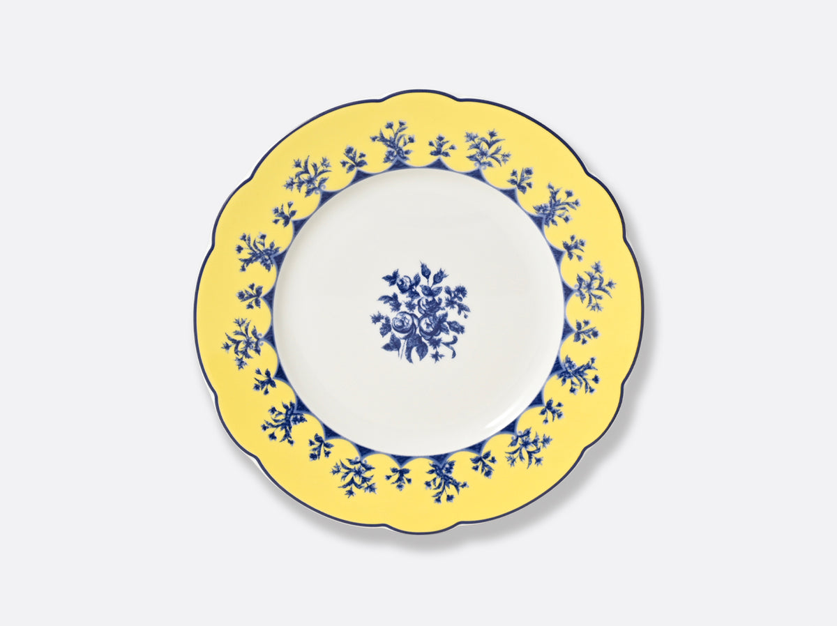 The Chateaubriand Dinnerware dessert plate by Bernardaud features a yellow scalloped edge, blue floral designs, and a matching center pattern, all set on a light gray background.