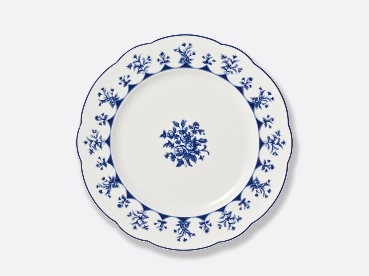 The Bernardaud Chateaubriand Dinnerware dessert plate is white ceramic with a scalloped edge, detailed blue floral pattern around the rim, and a central cluster of blue flowers against a plain background.