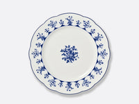 The Bernardaud Chateaubriand Dinnerware dessert plate is white ceramic with a scalloped edge, detailed blue floral pattern around the rim, and a central cluster of blue flowers against a plain background.