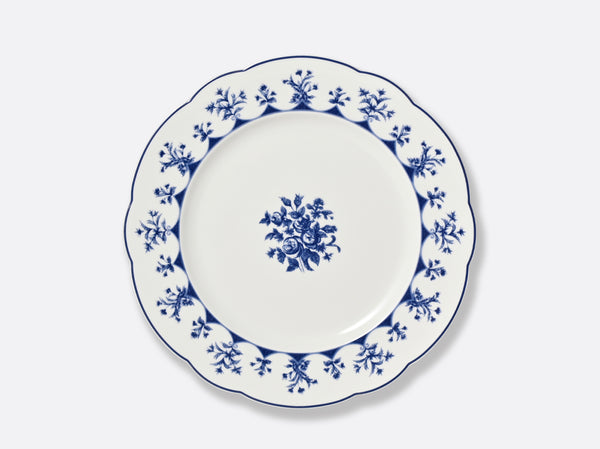 The Bernardaud Chateaubriand Dinnerware dessert plate is white ceramic with a scalloped edge, detailed blue floral pattern around the rim, and a central cluster of blue flowers against a plain background.
