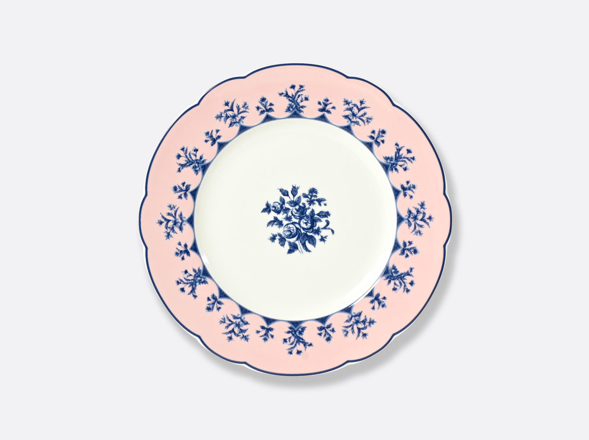 The Bernardaud Chateaubriand Dinnerware features a round ceramic dessert plate with scalloped edges, a pale pink border accented by blue florals, and a matching central motif—ideal for serving Chateaubriand.