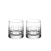 Two Christofle Graphik Barware tumblers, featuring a cut glass geometric pattern, sit side by side on a white background—elegant crystal glassware from Christofle’s Set of 2.
