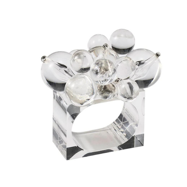 The Kim Seybert Cloud Napkin Ring Set of 4 features clear, rectangular Lucite rings adorned with varying sizes of transparent acrylic baubles, offering a modern, sculptural design.