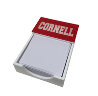 The Eye Candy College Note Pad features a white holder with a red top labeled CORNELL in bold white letters, stocked with blank square notes—perfect as a custom school pad or thoughtful graduation gift. Shown on a white background.