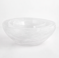 Three clear, handcrafted Gary Bodker Nesting Bowl White Cotton bowls are stacked on a plain white surface, highlighting the elegance of this stylish set.