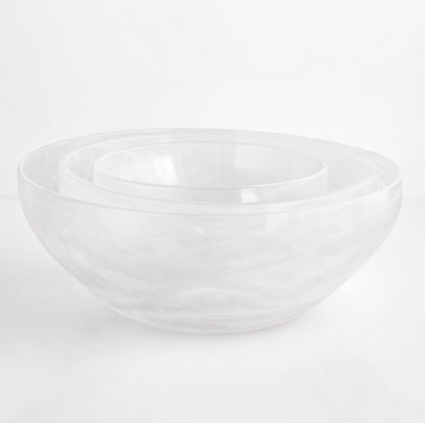 Three clear, handcrafted Gary Bodker Nesting Bowl White Cotton bowls are stacked on a plain white surface, highlighting the elegance of this stylish set.