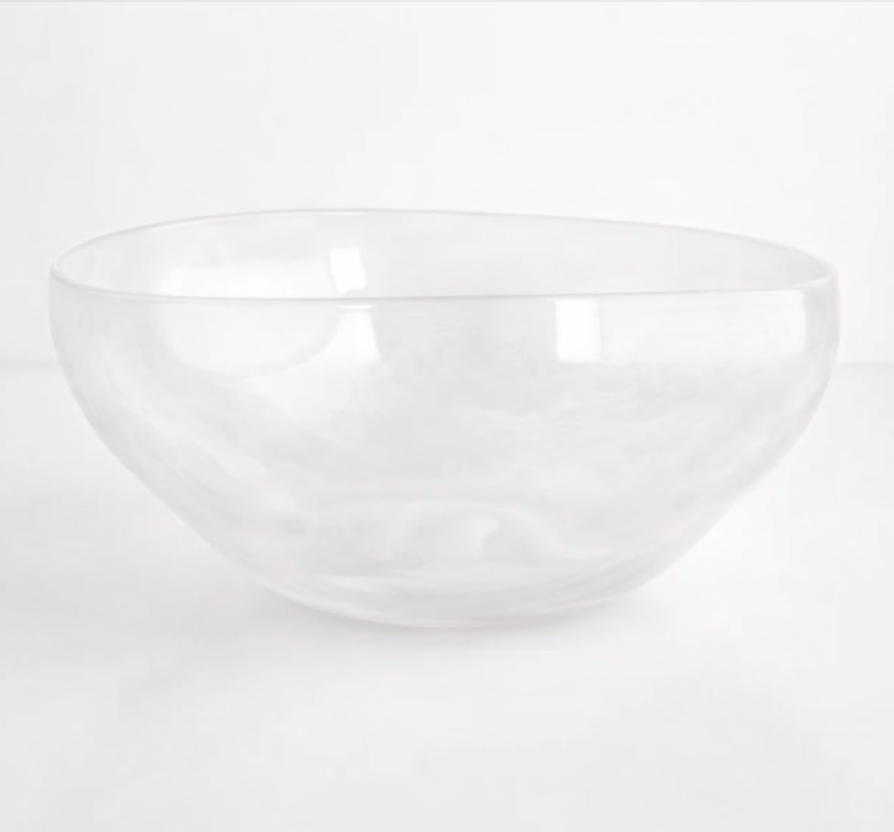 The Gary Bodker Nesting Bowl White Cotton is a handcrafted, clear, round glass bowl with smooth edges and a unique shape—ideal for serving or stacking as part of your bowl set.
