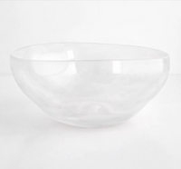 The Gary Bodker Nesting Bowl White Cotton is a handcrafted, clear, round glass bowl with smooth edges and a unique shape—ideal for serving or stacking as part of your bowl set.