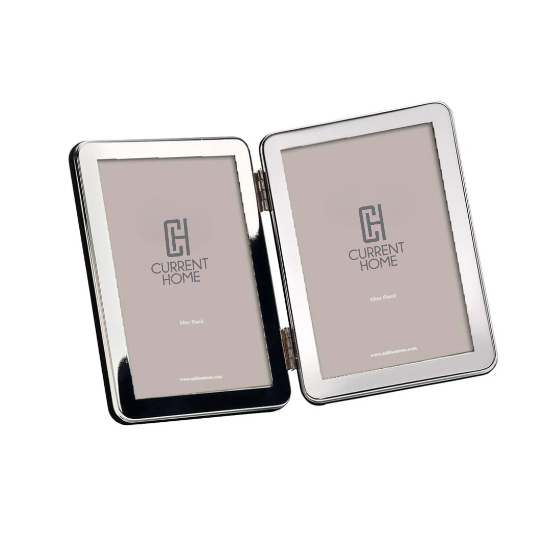 The Addison Ross Curved Double Frame is a silver-plated hinged frame with two 5x7 sections, each featuring a neutral background and placeholder with the Current Home logo.