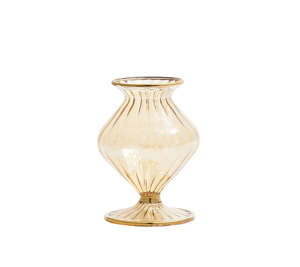 The Kim Seybert Champagne Rib Gold Detail Vase is a translucent, amber mouth-blown glass piece with iridescent luster, flared lip, ribbed texture, and wide round base. Its curvy hourglass silhouette stands out against a plain white background.