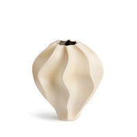 The Douro Vase Oat - Medium by L'Objet is a cream porcelain vase with a matte finish, sculpted wavy surface, and star-shaped opening—ideal as decor or gifted in its luxury box.
