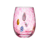 A set of four Gala Stemless Tumblers by Kim Seybert, crafted from colorful glass with vibrant pink speckled oval and round decorative accents, is displayed against a white background.
