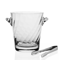 The Dakota Ice Bucket by William Yeoward features clear glass, two decorative side handles, and metal tongs—stylish for any wet bar or as a housewarming gift. Shown against a crisp white background.