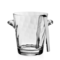 The William Yeoward Dakota Ice Bucket, crafted from clear glass with dual side handles and metal tongs on the rim, is a stylish addition to any wet bar or a perfect housewarming gift.