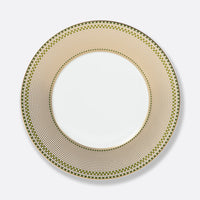 The Augusta Dinnerware plate by Bernardaud is a round white ceramic piece with a wide rim in a green and gold geometric Art Deco pattern, featuring a gold edge and plain white center.