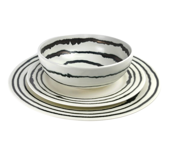 The Linea Dinnerware by Michael Wainwright includes a bowl, salad plate, and dinner plate, each featuring black wavy concentric rings on a white background.