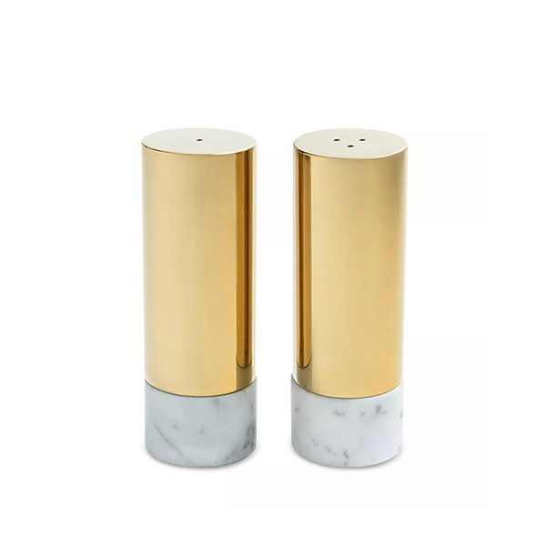 The Anna New York Dual Salt & Pepper Shakers Marble & Gold Set of 2 features two cylindrical shakers with Italian Carrara marble bases and gold metal tops, displayed side by side for a modern luxe touch.