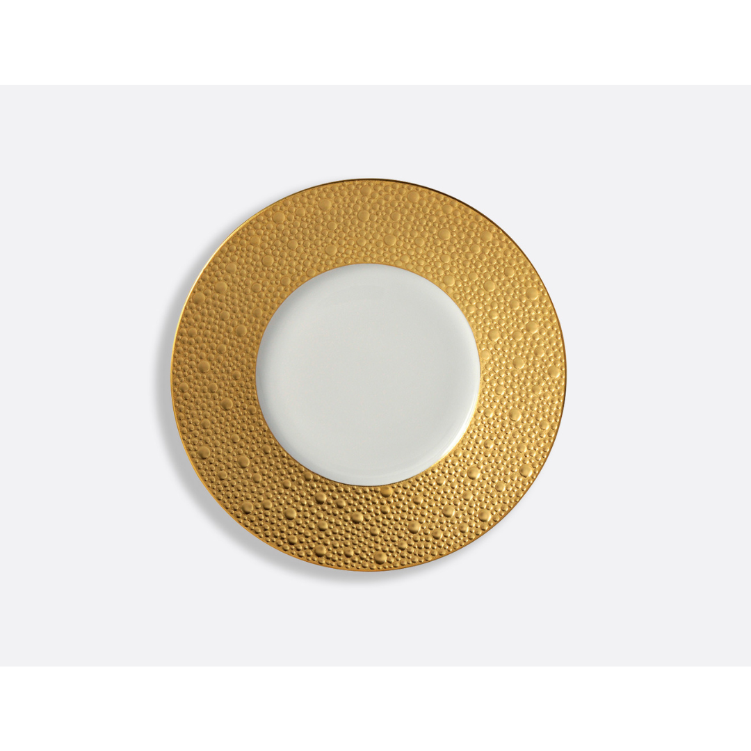 The Bernardaud Ecume Dinnerware Gold plate, crafted from Limoges porcelain, features a round white design with a wide textured gold rim and smooth center, shown from above on a plain white background.