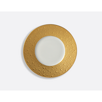 The Bernardaud Ecume Dinnerware Gold plate, crafted from Limoges porcelain, features a round white design with a wide textured gold rim and smooth center, shown from above on a plain white background.