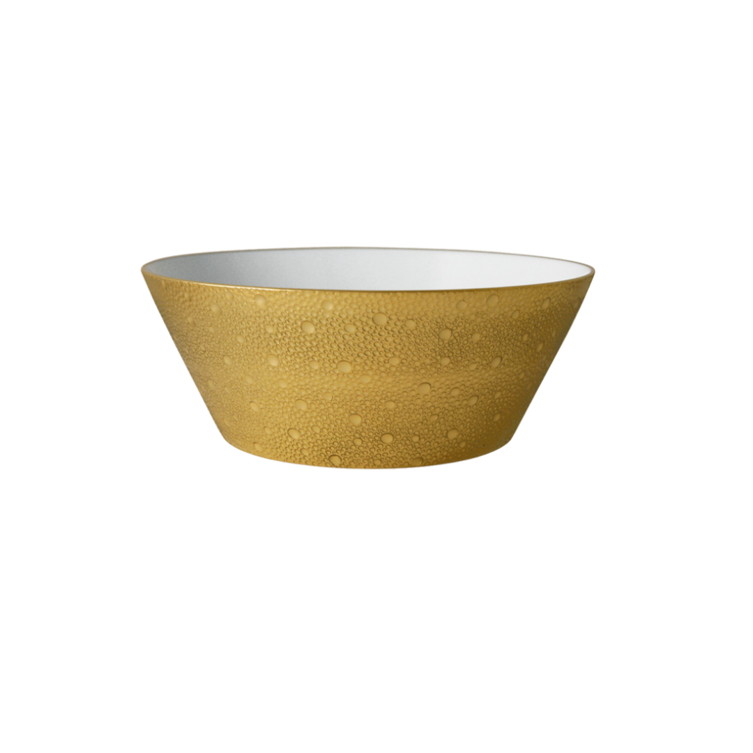 The Ecume Dinnerware Gold by Bernardaud is a yellow ceramic bowl featuring a textured, dotted exterior and smooth white interior, inspired by contemporary tableware, displayed against a plain white background.