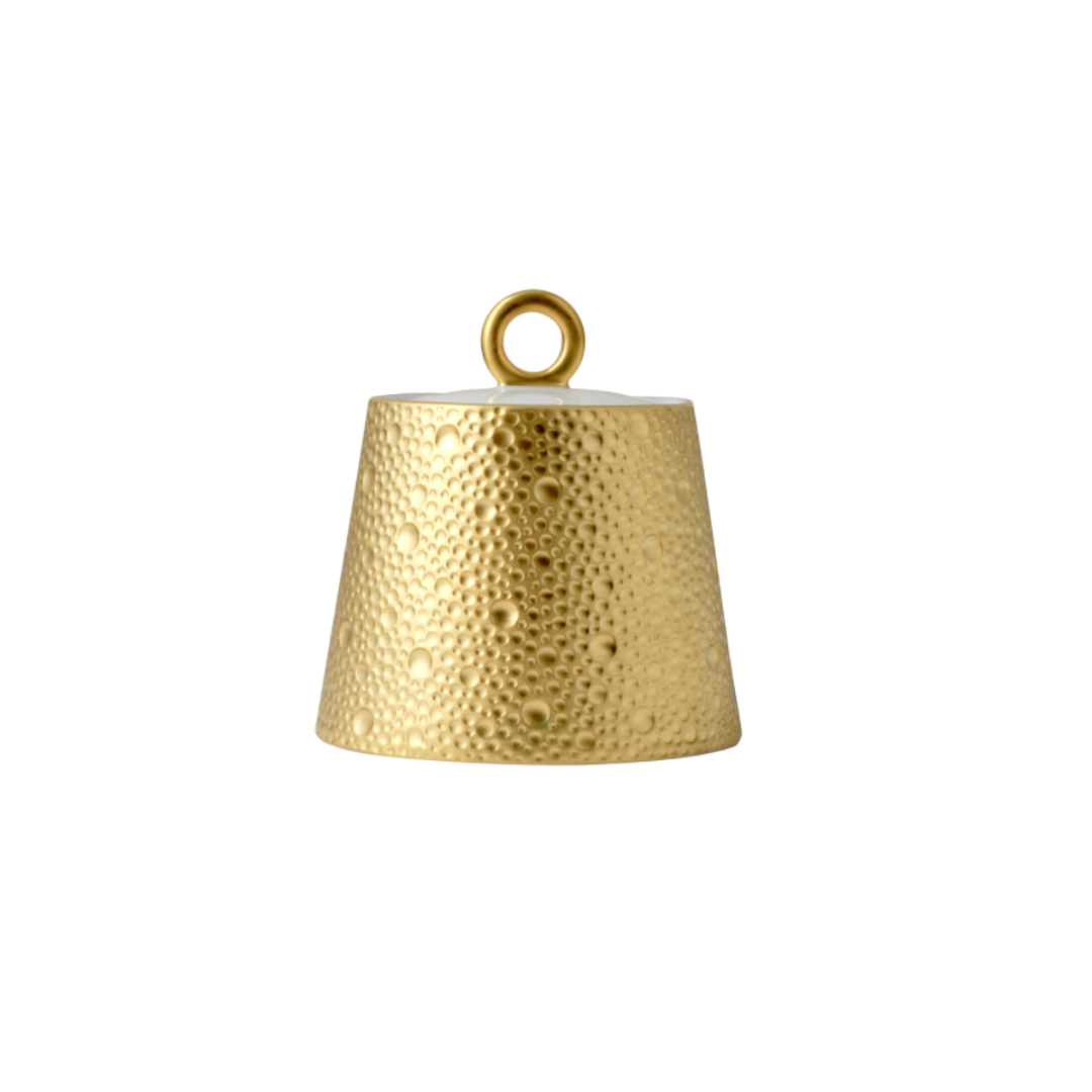 The Ecume Dinnerware Gold by Bernardaud features a gold, textured, conical design with a loop for hanging. Inspired by contemporary tableware, its surface has raised bumps for a hammered metal look.