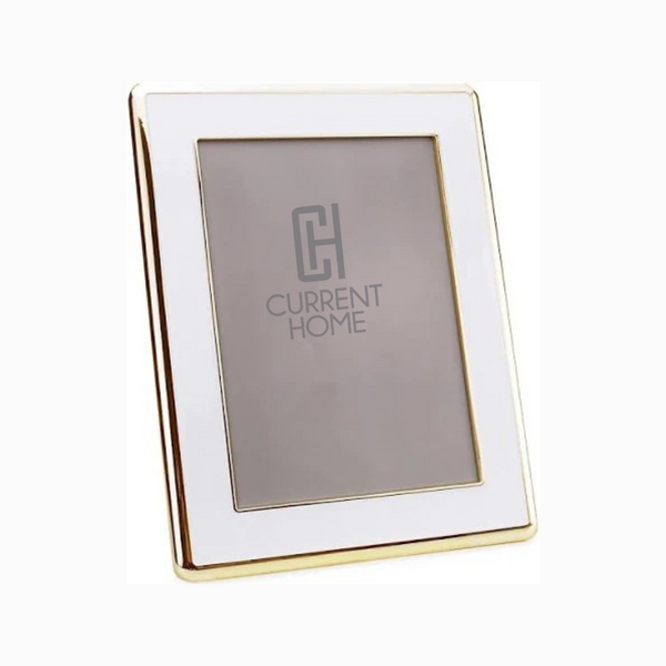 The Addison Ross Enamel Wide Gold & White Frame stands upright, its gold-trimmed border adding sophistication and elegance to any space, while offering a stylish blank canvas for your favorite photo.