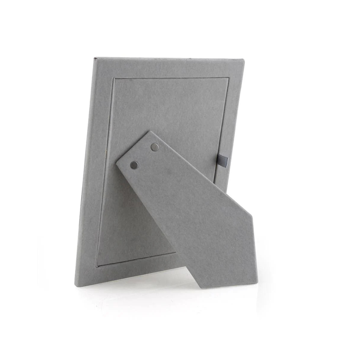 The Addison Ross Enamel Thin Chiffon Silver Frame is shown from the back with its stand extended, ready for upright portrait or landscape display. The empty frame contrasts against a white background.
