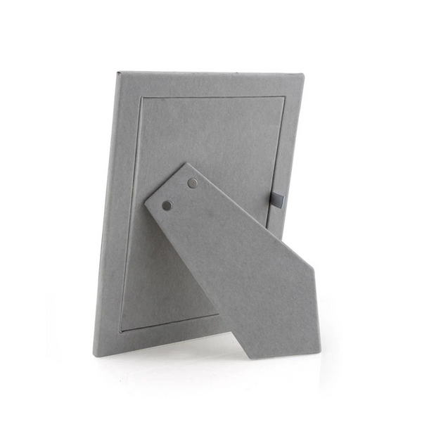 The Addison Ross Enamel Thin Chiffon Silver Frame is shown from the back with its stand extended, ready for upright portrait or landscape display. The empty frame contrasts against a white background.