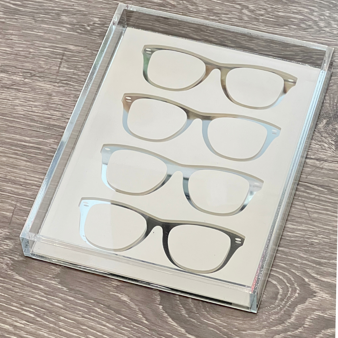 The Eye Candy Specs Eyeglass Tray neatly displays four pairs of black-framed glasses on a white background atop a light wood surface.