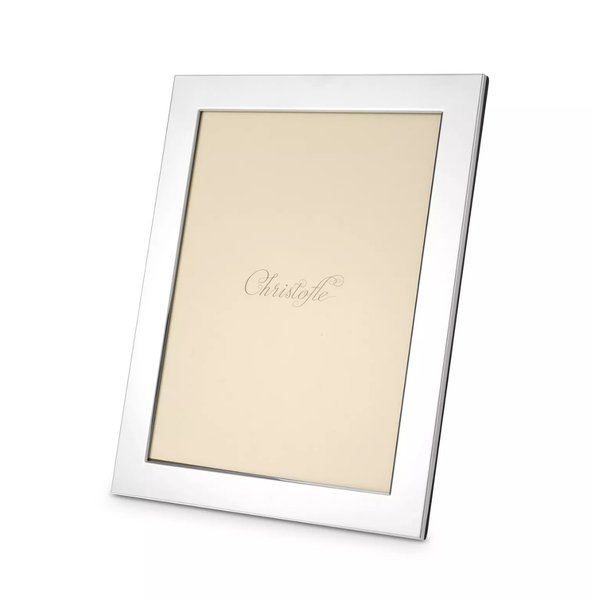 The Fidelio Christofle Silver Plated Frame (5x7) by Christofle is a sleek, rectangular silver-plated frame with a beige placeholder inside, shown at an angle, featuring elegant cursive writing in the center.