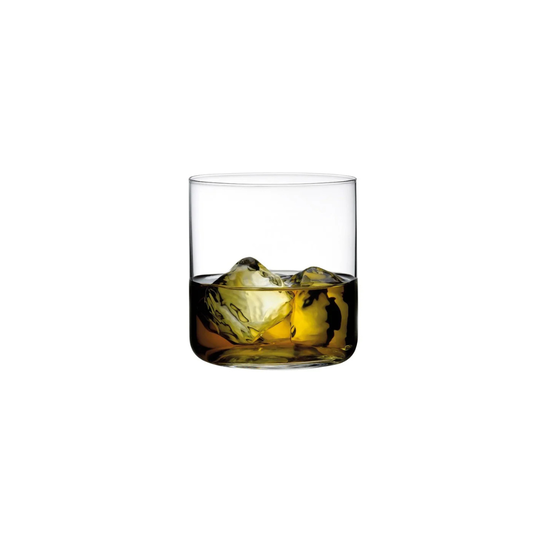 A clear glass from the Finesse Barware Set of 4 by Nude Glassware, crafted from lead-free crystal, is filled with golden-brown liquid and two large ice cubes, set against a plain white background.