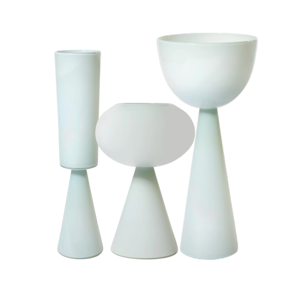 The Fiorelli Vases Ash by Current Home NY are four modern white ceramic vases with minimalist geometric designs and varying heights, arranged side by side against a white background.