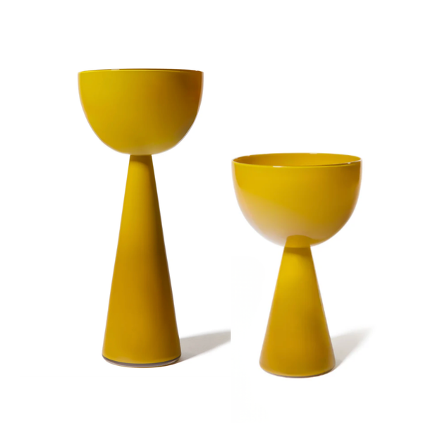 Two modern ceramic planters from the Fiorelli Collection Mustard by Current Home NY—one tall and slender, the other shorter and wider—feature conical bases and wide bowls in mustard yellow, displayed against a white background.
