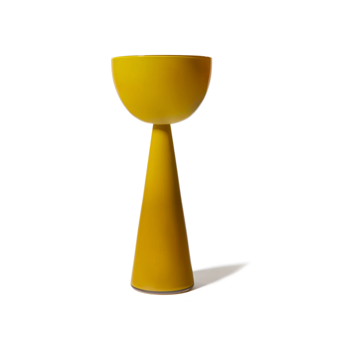 The Fiorelli Collection Mustard by Current Home NY features a modern, yellow ceramic planter with a wide bowl top and tall tapered base—an eye-catching piece ideal for floral arrangements, shown against a plain white background.